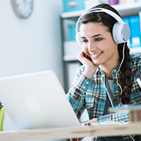 girl_with_headphones_using_a_laptop_iStock-512058584_blog_square_200x200