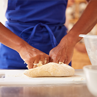 woman kneading bread